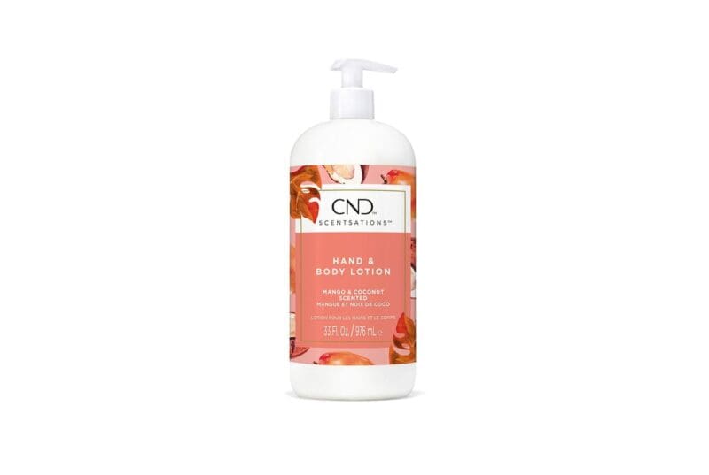 A bottle of CND Scentsations Hand & Body Lotion 33oz infused with a refreshing mango and coconut scent. The white bottle, equipped with a convenient pump dispenser, showcases vibrant fruit illustrations and detailed product information on its label.