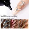 Close-up of a nail adorned with rhinestones applied using KYE 3-in-1 Nail Rhinestone Glue 30g. Below, three different nail art designs display rhinestones and intricate patterns. Text reads, "KYE 3-in-1 Nail Rhinestone Glue: Essential for Artistic Nail Creation.